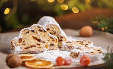 Slices of Christmas stollen on wooden background. Traditional Christmas festive pastry dessert. Stollen is treat for Christmas
