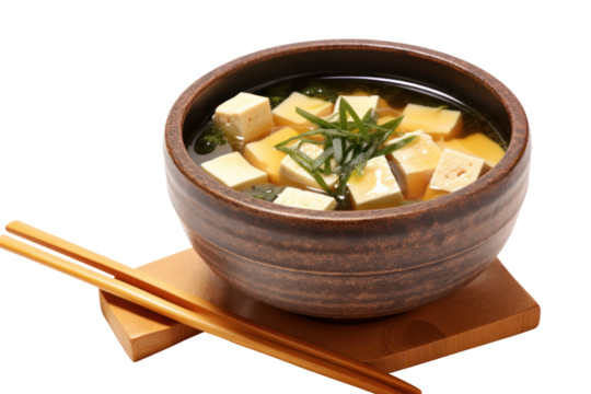 Miso soup in a traditional Japanese bowl with tofu cubes and seaweed floating on the surface isolated on white background - Powered by Adobe