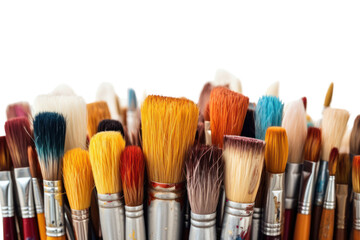 Fototapeta premium Close-up view of several paintbrushes with wooden handles and different bristle types, spread out in an organized manner on a white background