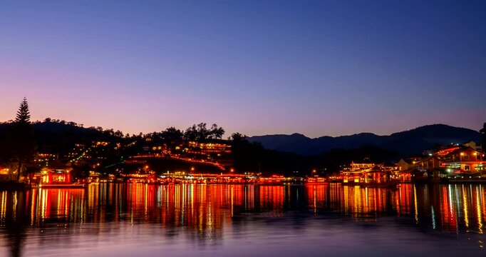 Time-lapse ambient day to night of "Ban Ruk Thai village" beside a beautiful lake, a Village of Chinese settlement is a travel destination in Mae Hong Son province, Amazing Thailand