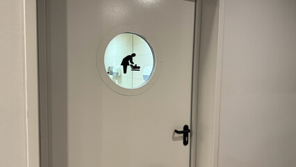 Door to baby changing room with symbol for help mothers with children