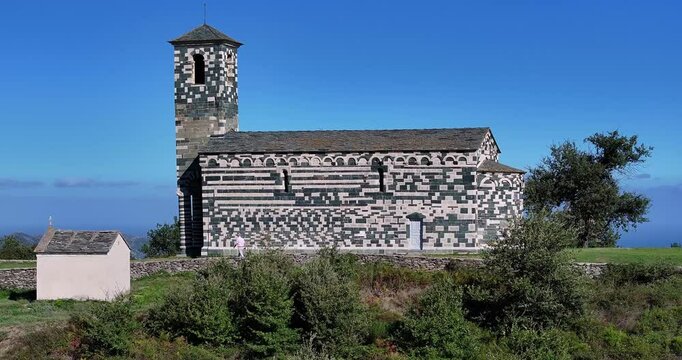 Aerial drone video of the historic San Michele de Murato church in Corsica with scenic landscape towards Cap Corse