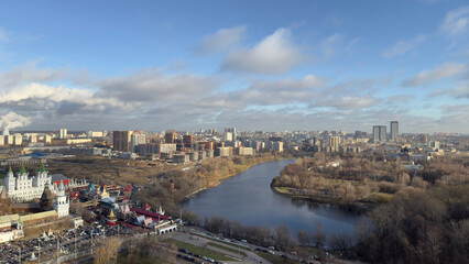Panorama of Moscow from above overlooking buildings and pond on cold winter day