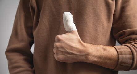 Man with a injured finger with bandage.