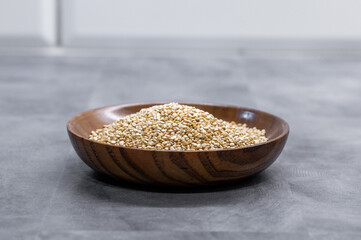 Heap of quinoa in a wooden bowl
