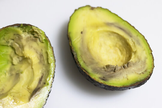 Avocados are rotten if they're mushy when squeezed, brown or moldy inside, and have developed rancidity or a sour smell.