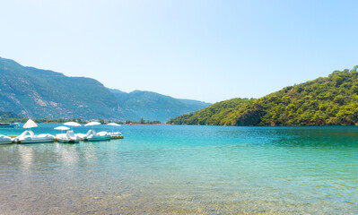 View of Blue Lagoon with Sun Loungers and Umbrellas Along a Tropical Beach on a Clear Summer Day