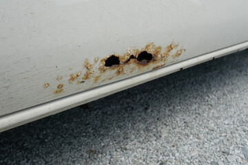 Vehicle Corrosion Assessment: The image highlights severe rust damage on a vehicle, indicating the...