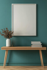 A white framed picture sits on a table next to a vase of flowers. The room is decorated with green walls and a wooden table. 