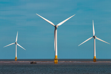 Offshore wind turbines farm on the ocean. Sustainable energy production, clean power, windmill. 