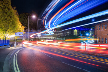 York City street at night lit up by a passing bus. UK