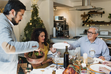 Latin family having Christmas dinner at home in Mexico Latin America, hispanic people eating at holidays or thanksgiving tradition