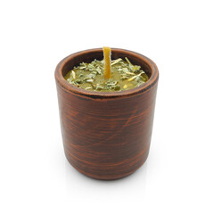 Herbal ritual candle from natural ingredients, beeswax and dried wild plants, in clay pot isolated...