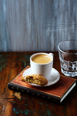 Cup of coffee and Cantuccini (Italian cookie) on dark wooden background. Copy space.