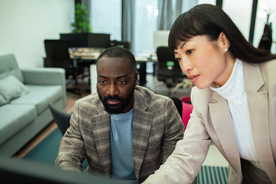 Diverse business people working together on office computer