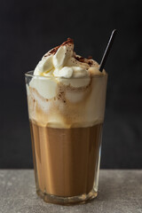 Coffee drink with whipped cream and cinnamon. Home made beverage background