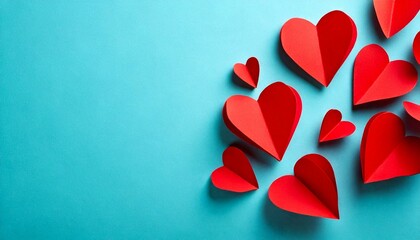 Red paper hearts on blue background