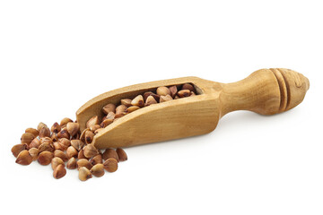Raw buckwheat in wooden scoop isolated on white background