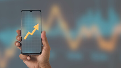 Business analyst forex trading and upward arrow on mobile with graph blur background. Represents...