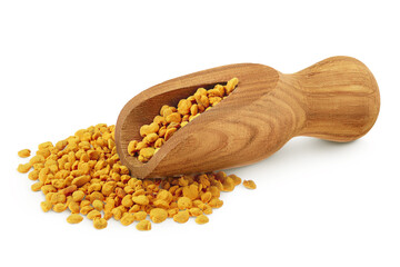 Bee pollen grains in wooden scoop isolated on white background