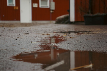 Close up of a puddle on front of a building