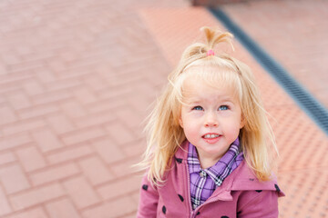 Portrait of a Caucasian child girl toddler outside in summer.