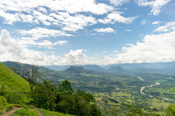 Obraz premium Beautiful natural landscape of the Poblanco river in southwestern Antioquia, Colombia with mountains in the background aerial view.