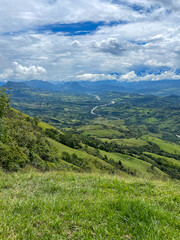 Naklejka premium Beautiful natural landscape of the Poblanco river in southwestern Antioquia, Colombia with mountains in the background aerial view.