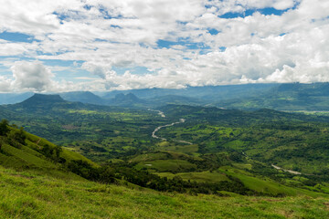 Obraz premium Beautiful natural landscape of the Poblanco river in southwestern Antioquia, Colombia with mountains in the background aerial view.