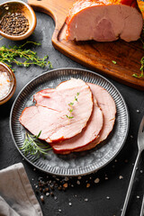 Sliced cold pork meat top view, boiled pork on black background