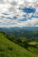 Beautiful natural landscape of the Poblanco river in southwestern Antioquia, Colombia with mountains in the background aerial view.