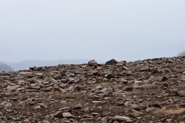 Rocks covering a hill with foggy background