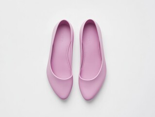 A pair of pink ballet flats displayed on a white background.