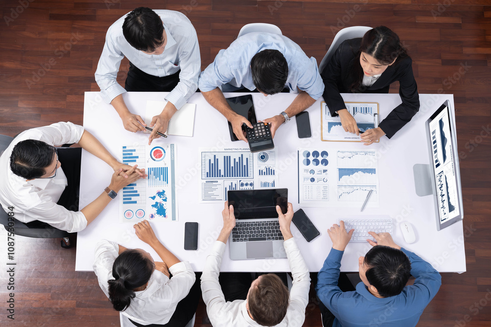Leinwandbilder Top view analyst team utilizing BI Fintech to analyze financial data at table in meeting room. Analytic BI dashboard power on paper for business insight and strategic marketing planning. Prudent