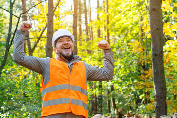 Obraz premium Successful forest engineer in uniform. Environmentalist for nature conservation. National parks protection. Construction of eco houses in the forest. Ecologist. 