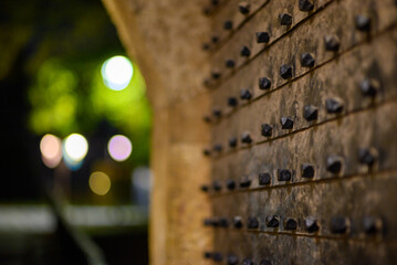 Metal door at gate in Belgrade Fortress fortifications in Kalemegdan park at night in Belgrade, Serbia