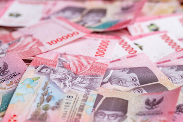 Indonesia money, stack of 100000 thousand Indonesian rupiah banknotes. New paper banknotes, Business concept. Financial background