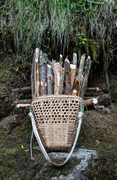 Nepali basket,a doko, full of cut firewood, propped on a rock in Khumbu, Nepal.