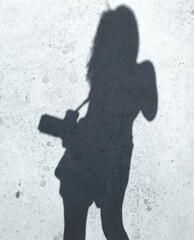 silhouette - shadow of a woman with a camera