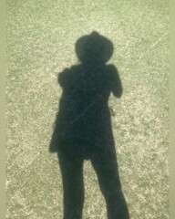 silhouette, shadow of a woman wearing hat