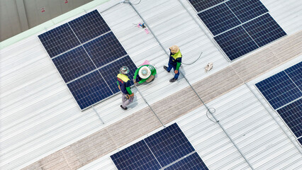 A team of technicians inspects solar panels on metal rooftop, equipped with tools, laptops, and safety gear. A scene highlights teamwork in renewable energy maintenance and sustainable infrastructure.