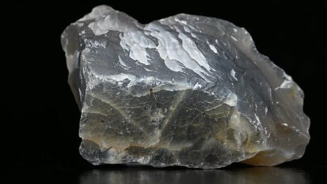 Blue / grey Agate - form of chalcedony found within volcanic and metamorphic rocks - rotating against a black background