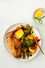 Enjoy a delicious, hearty meal with baked rabbit, roasted potatoes, and carrot salad, combining savory flavors and wholesome ingredients for a nutritious and satisfying dinner