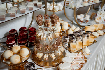 A table full of desserts including cakes, cookies, and pastries. The desserts are arranged in a way that makes them look like a tower
