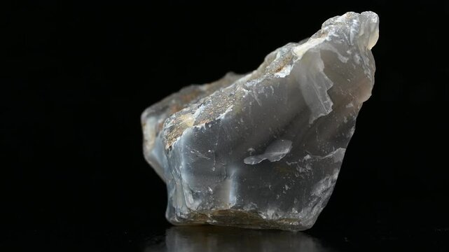 Blue / grey Agate - form of chalcedony found within volcanic and metamorphic rocks - rotating against a black background