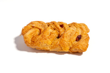 A pastry with a cinnamon swirl on top. It is a cinnamon roll. The pastry is sitting on a white background Sweet pastries isolated on white background.