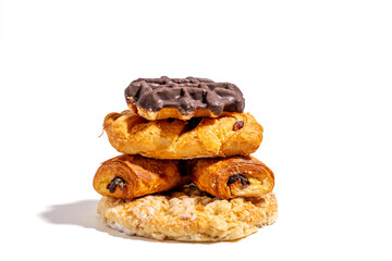 A stack of pastries with a chocolate topping. The pastries are arranged in a pyramid shape, with the bottom layer being a plain croissant, the middle layer being a chocolate-covered croissant Sweet pa