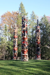 Three Carved Totem Poles in a Landscape Setting