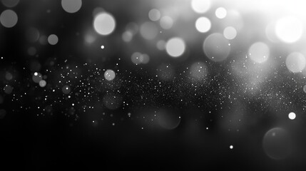 Blurred glittering dust particles floating on black background creating a magical bokeh effect