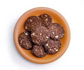 group of chocolate oatmeal cookies on a round plate, isolated on white background